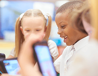 Happy students using tablets
