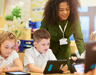 Teacher observing student on tablet